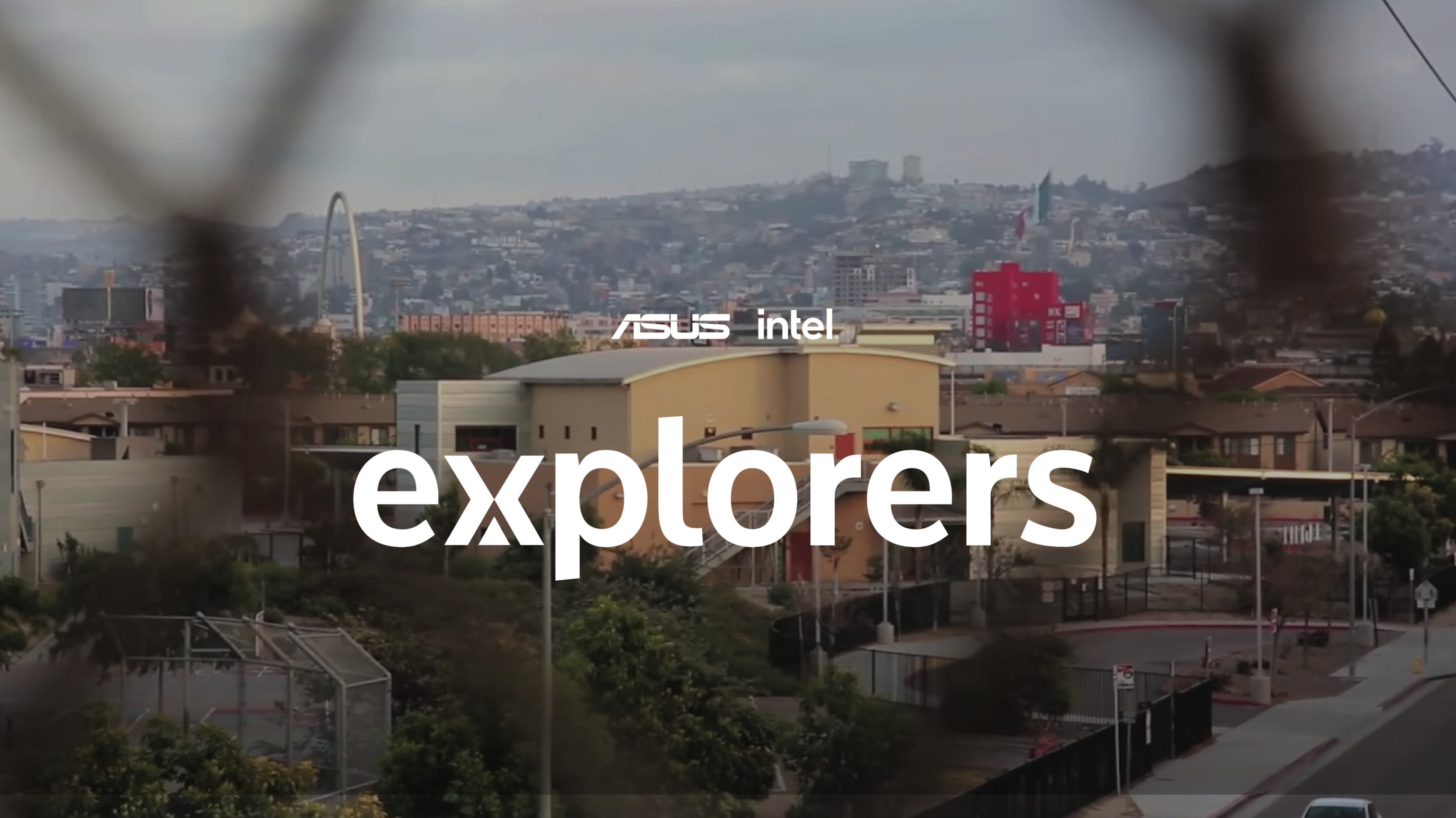 two people sitting on a ledge talking